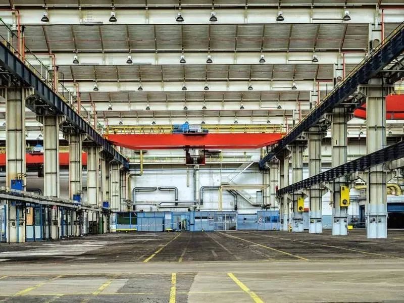 An industrial plant floor with overhead cranes