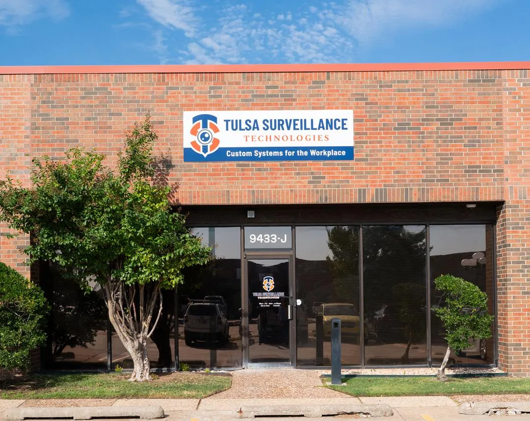 The Tulsa Surveillance Technologies building exterior with the company sign